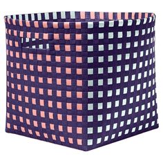 a blue and pink basket sitting on top of a table