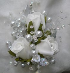 a bridal bouquet with white roses and pearls