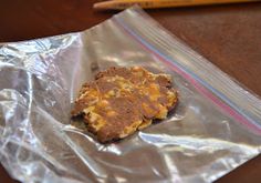 a cookie sitting on top of a piece of tin foil next to a pencil and paper