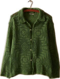 a green sweater hanging on a clothes hanger with an openwork design in the middle