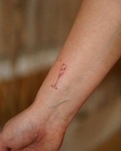 a person's foot with a small tattoo on the left side of their arm