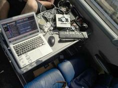 a laptop computer sitting on top of a table next to a keyboard and mouse in front of a window