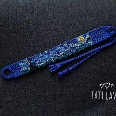 a blue lanyard with an image of the starry night on it and some hearts