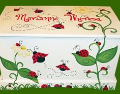 a decorative box with ladybugs painted on the side and flowers in the middle