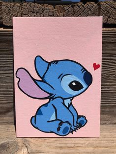 a painting of a little blue elephant sitting on top of a piece of pink paper