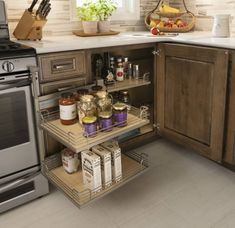 a kitchen with stainless steel appliances and shelves filled with spices, condiments, and other items