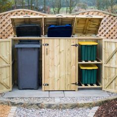 an outdoor storage area with trash cans and bins