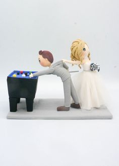 "Funny wedding cake topper, Bride pull groom away the pool table topper, white and red wedding theme, hobby related wedding topper is not just perfect for only the big day. These unique keepsakes are designed to be kept forever, reminding you of your super special day. They are designed to tell your unique story, to every generation to come. These are 100% hand made so each wedding cake topper is absolute one-and-only in this world. Let us help create the unique wedding cake topper for your wedd Pool Table Topper, White And Red Wedding Theme, Funny Wedding Cakes, Playing Pool, Funny Wedding Cake Toppers, Funny Bride, Wedding Cake Toppers Unique, Pool Wedding, Red Wedding Theme