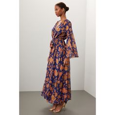 Blue floral chiffon (97% Polyester, 3% Metallic). A-line. Long sleeves. V-neck. Pull on. 58" from shoulder to hemline. Made in the USA of imported fabric. Flowy Floral Print V-neck Dress, Flowy V-neck Lined Maxi Dress, Chic Flowy V-neck Dress With Floral Print, Blue Floral Print Chiffon Maxi Dress, V-neck Chiffon Printed Dresses, Chiffon Maxi Dress With Floral Print And Surplice Neckline, Blue Flowy Maxi Dress For Garden Party, V-neck Chiffon Maxi Dress With Floral Print, Flowy Floral Maxi Dress With Surplice Neckline