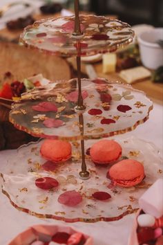 three tiered trays filled with pastries on top of a table