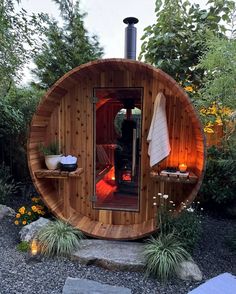 an outdoor sauna is lit up with candles