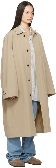 Washed cotton poplin trench coat. · Button fastening at spread collar · Concealed button closure · Welt pockets · Raglan sleeves · Adjustable button tab at cuffs · Horn hardware Supplier color: Light taupe Classic Cotton Outerwear For Daywear, Classic Oversized Outerwear With Button Cuffs, Gabardine Button-up Outerwear With Button Cuffs, Classic Outerwear With Button Cuffs, Classic Outerwear With Button Cuffs For Daywear, Classic Oversized Outerwear With Spread Collar, Gabardine Button-up Outerwear With Hidden Button Closure, Buttoned Gabardine Outerwear, Mac Coat