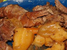 a blue plate topped with meat and potatoes