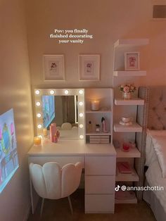 a white vanity with lights on it next to a bed and desk in a room