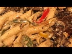 a pasta dish with mushrooms, peppers and cheese