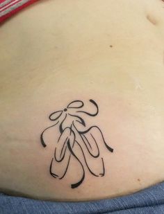 the back of a woman's stomach with an image of a tattoo on it