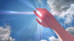 a person's hand reaching up into the sky with clouds and sun in the background