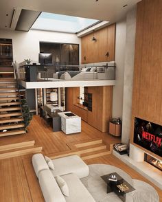 a living room filled with furniture and a flat screen tv on top of a hard wood floor