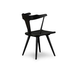 a black wooden chair sitting on top of a white floor