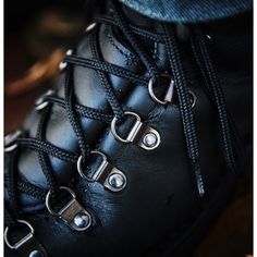 a pair of black boots with laces on them