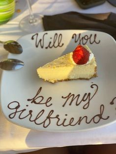 a piece of cheesecake on a white plate with the words will you be my girlfriend?