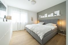 a bed sitting in the middle of a bedroom next to a window