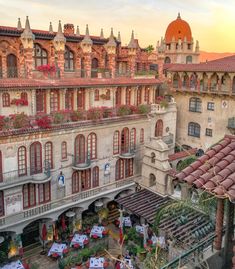 an old building with many windows and balconies on the top floor is shown at sunset