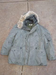 N-3B Military Nylon Coat Parka  Jacket  Condition: Good used Condition Some Stains.    SHIPPING POLICY: Item will be ship 3 to 5 days after payment is clear. COMBINED SHIPPING POLICY: Additional items priced $15.00 PAYMENTS: full payment is due within Three days. Requests for extra time to pay must be made before the payment due day. RETURN POLICIES We do not accept returns on any of our items,THE SHIRT IS A PREWORN. Please email any specific questions you have regarding the items and our polici Vintage Nylon Outerwear For Fall, Military Style Long Sleeve Windbreaker For Cold Weather, Military Style Outerwear With Double-lined Hood, Military Style Windproof Outerwear For Cold Weather, Military Style Outerwear With Double-lined Hood And Long Sleeve, Military Style Long Sleeve Parka For Cold Weather, Military Style Long Sleeve Outerwear With Double-lined Hood, Vintage Nylon Long Sleeve Outerwear, Khaki Long Sleeve Nylon Parka