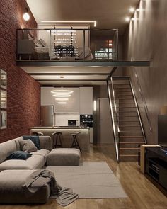 a living room filled with furniture and a stair case in front of a brick wall