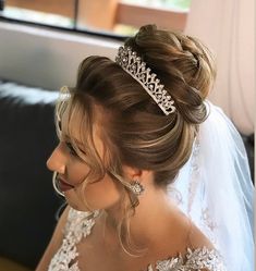 a woman wearing a tiara sitting on a couch