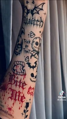 a person with tattoos on their arm and hand is covered in red ink that reads, trick or treat