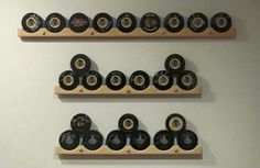 two wooden shelves filled with hockey pucks on top of each other in front of a white wall