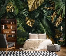 a bedroom with a bed, chair and wallpaper that has tropical leaves on it