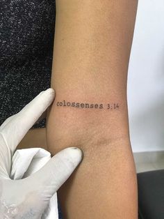 someone is holding their arm with the word colossenses on it