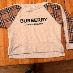 Kids Size 10 (140cm) Burberry Sweatshirt In Excellent Condition. Black Raised Logo Lettering On Grey Background, Satin Burberry Plaid Sleeves, Split Hem With Slight Cropping In Front Burberry Sweatshirt, Burberry Shirts, Burberry Plaid, Plaid Sleeve, Burberry Kids, Grey Background, Burberry London, Gray Background, Split Hem