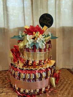 a three tiered cake with candy wrapped around it