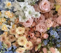 a bunch of flowers that are in the middle of some kind of flower arrangement on a table