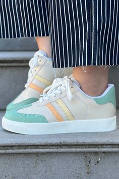 A simple sneaker with pastel colors and a comfortable fit. They are a low ankle sneaker with stripes and laces. Style with a jumpsuit or jeans for a casual look. Heel Height: 1.25" Trendy Green Sneakers For Spring, Casual High-top Platform Sneakers With Elastic Laces, Sporty Striped Lace-up Sneakers, Green Lace-up Platform Sneakers For Spring, Spring Green Lace-up Platform Sneakers, White Platform Sneakers With Elastic Laces, Casual, White Casual Platform Sneakers With Elastic Laces, Casual White Platform Sneakers With Elastic Laces, Casual Green Platform Sneakers With Round Toe