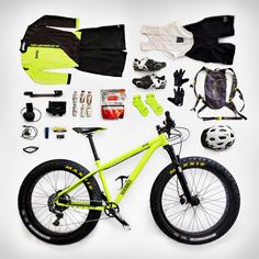 a bicycle with all the necessary gear and accessories laid out on it's side