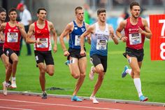 the men are running on the track in their uniforms and numbers for each race they're competing