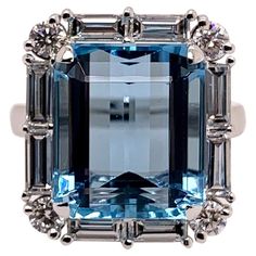 This stunning, ocean blue aquamarine has amazing blue hues and is cut exceptionally well to radiate in any environment. The setting is handmade in platinum and is precisely surrounded by handpicked diamond baguettes and round diamonds that accentuate the symmetry of the aquamarine. Aquamarine: 9.85 carats, emerald cut Diamonds: 1.49 carats, baguettes & round brilliant diamonds Platinum Ring Size: 6.5 & can be sized. One of a kind, cannot be reproduced. Luxury Fine Jewelry Topaz Baguette Cut Ring, Luxury Blue Topaz Jewelry With Diamond Accents, Exquisite Luxury Topaz Ring For Anniversary, Blue Diamond Ring With Baguette Diamonds, Gia Certified Blue Topaz Ring With Diamond, Gia Certified Blue Topaz Diamond Ring, Luxury Light Blue Brilliant Cut Topaz Ring, Luxury Blue Topaz Ring Gia Certified, Luxury Blue Topaz Ring In Platinum