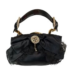 Authentic Rare Vintage Dolce & Gabbana Evening Bag Dolce & Gabbana Signature Style. This Exquisite Evening Bag Is A Perfect Accessory For Any Special Occasion, It Will Lift Any Evening Ensemble From Great To Stunning. Black Silk Satin Silk & Lace Bow At The Front Crystal & Rhinestone Brooch With Dangly Logo Charms. Small Handle Made From Patent Leather With Two Rhinestone Paved Buckles. Small Rhinestone Embellished Studs At The Bottom Of The Bag. Gold Hardware Kiss-Lock Closure Beautiful Pale Pi Maroon Leather, Clutch Black, Heart Bag, Silk Lace, Lace Bows, Purple Velvet, Black Leather Bags, Satin Silk, Evening Clutch Bag