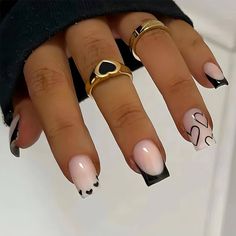 a woman's manicured nails with black and white designs on the tip of each nail