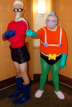 two people in costumes are standing next to each other and one is wearing an orange shirt