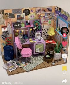 a doll house with furniture and decorations on the walls, including a desk and chair