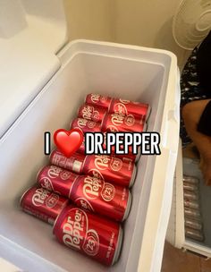 an open refrigerator filled with cans of soda and a red heart in the bottom right corner