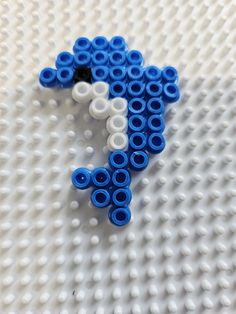 a blue and white elephant made out of legos sitting on top of a table