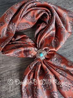 "All shop orders of $35 or more receive FREE SHIPPING within the USA  ooooooooooo  Color: Dark Rust Orange with spur like paisleys and conchos - ALSO AVAILABLE IN HUNTER GREEN (SEPERATE LISTING) Size: 19\"x19\", 35\"x35\", 27\"x27\", 40\"x40\", or 44\"x44\"  Material: Silk Charmeuse Polyester Weight: Lightweight and Silky Soft Hem: Rolled (not surged) ooooooooooo SLIDE SOLD SEPERATELY - ALSO AVAILABLE IN HUNTER GREEN Charmuese is a luxurious, supple silky fabric with a shiny satin face and a dull back. Generally either silk, rayon ,or polyester. This is a fabric that is more durable, yet just as pretty as a 100% silk scarf. Please note that these neck scarves are custom designed. I choose only the highest quality of fabrics. I am a semi-professional seamstress, who also is a stay at home m Scarf Slides Western, Western Wild Rags, Western Neck Scarf, Scarf Slides, Western Scarf, Ranch Riding, Western Wild, Wild Rags, Double B