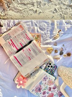 an open book sitting on top of a white sheet