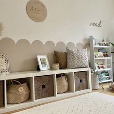 a living room filled with lots of furniture and baskets on top of the shelfs